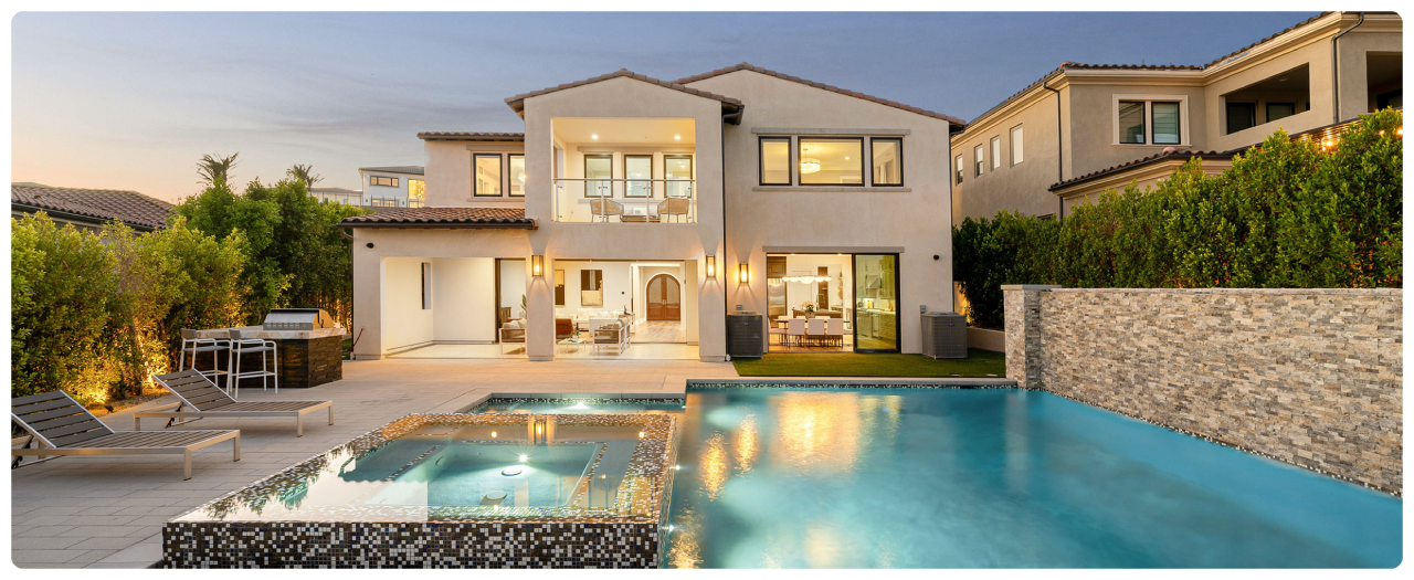 Elegant home exterior featuring a spacious pool