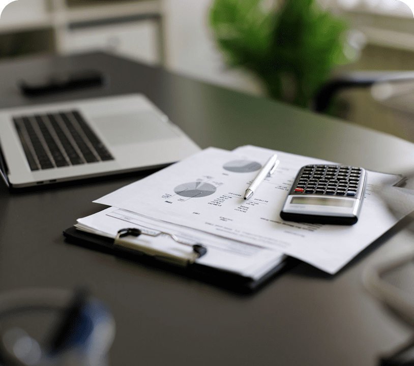 Workspace with laptop and financial charts